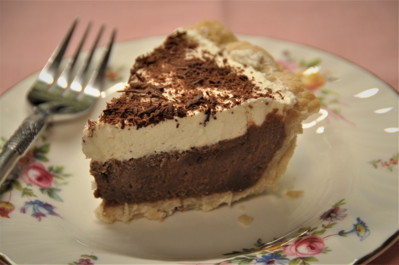 Luscious, silky mocha chocolate pie with whipped cream and chocolate curls on top.