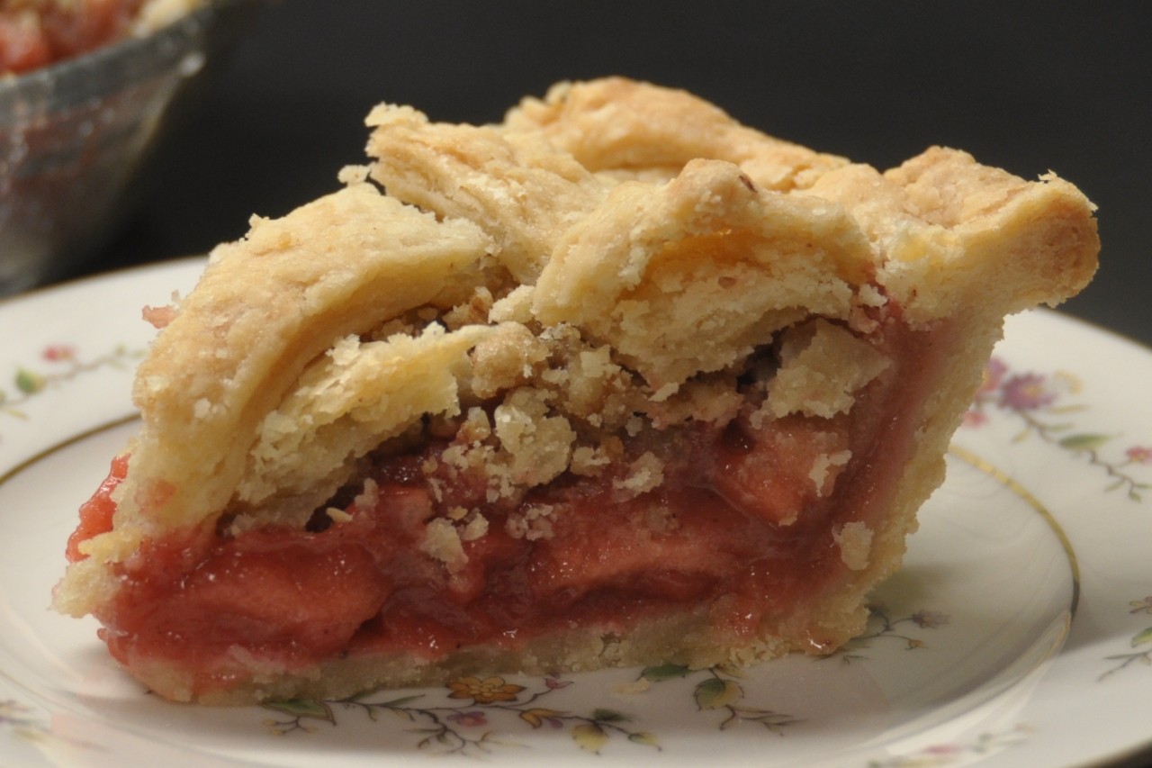 Apple pie is made colorful with fresh cranberry puree and an easy-to-make praline topping.