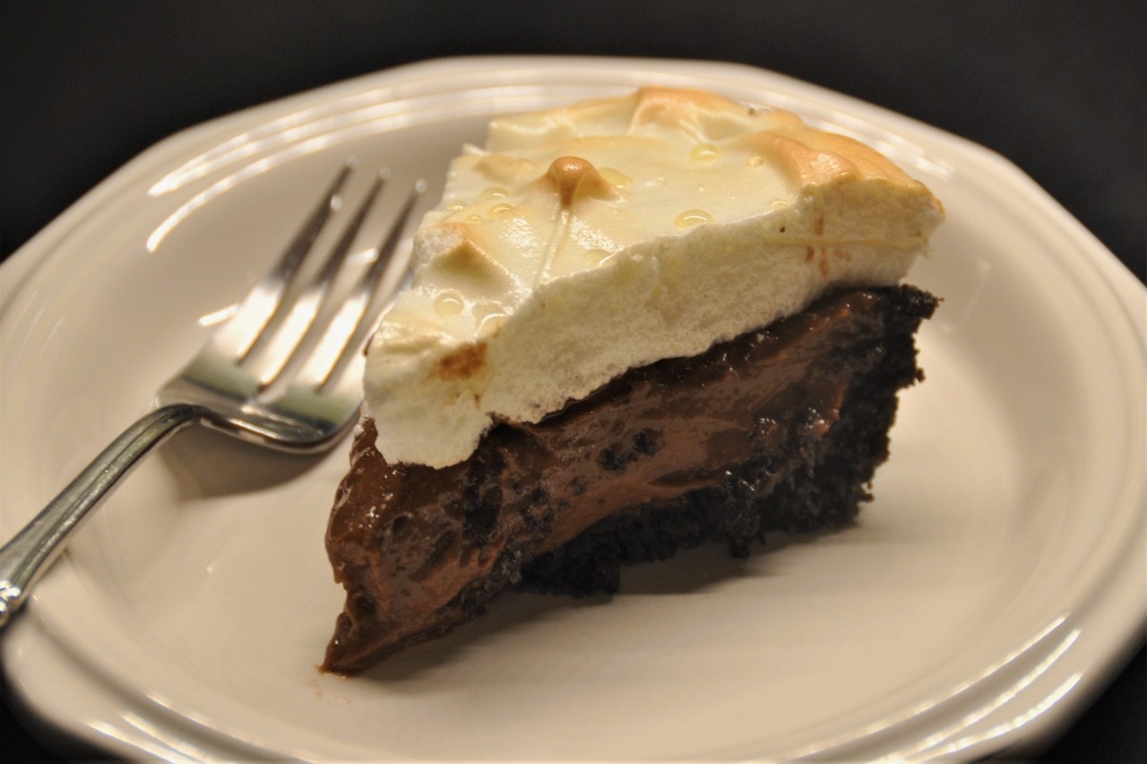 Rich and creamy chocolate pudding pie with a crushed chocolate wafer crust and meringue topping.
